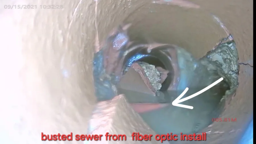 Fiber-optic cable running through a sewer pipe after being drilled through during installation